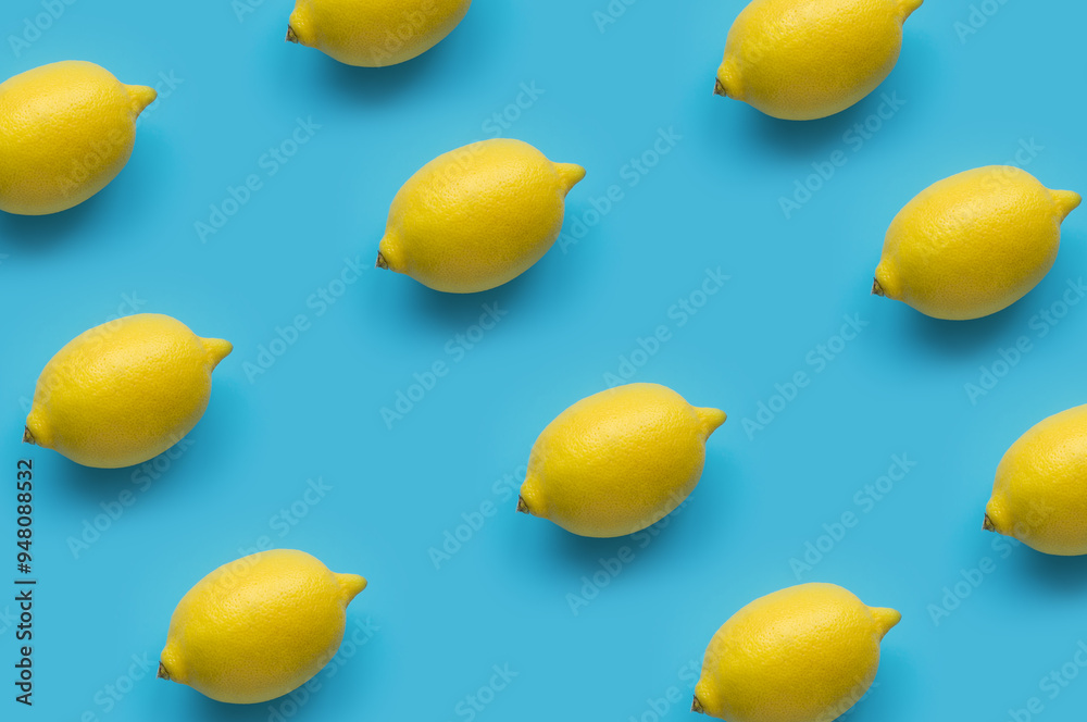 Fresh, ripe lemons on blue background. Top view