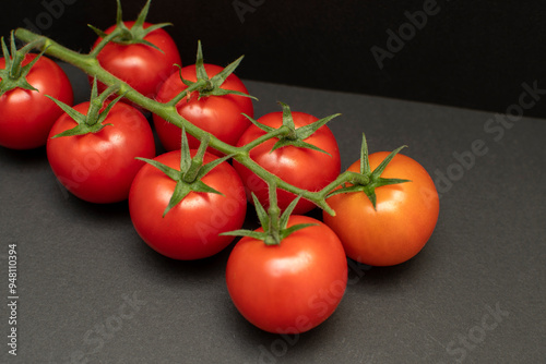 A tomatoes on black background	 photo