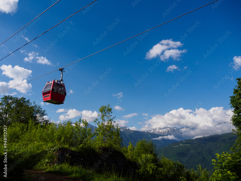 The cable car glides over picturesque mountain scenery, offering breathtaking views and an atmosphere of adventure at altitude The cable car glides over picturesque mountain scenery, offering breathtaking views and an atmosphere of adventure at altitude