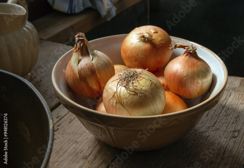 Onions in historic kitchen of Bodmin castle in kitchen in England. Lanhydrock Cornwall. Bowl of onions. photo