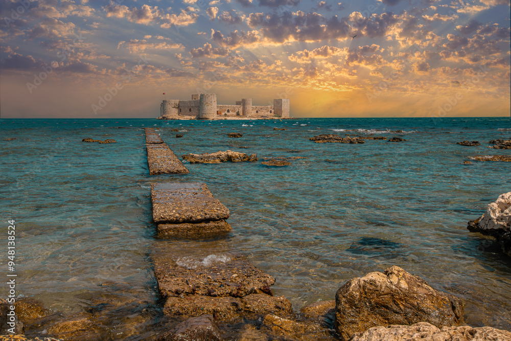 Cloudy sky and Maiden Castle (Kız Kalesi) and rocky field - Mersin, Türkiye.