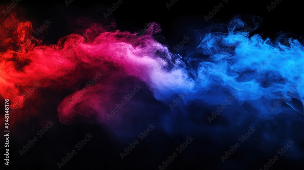 Obraz premium A vibrant swirl of red and blue smoke against a black background, creating an energetic and dynamic visual effect.