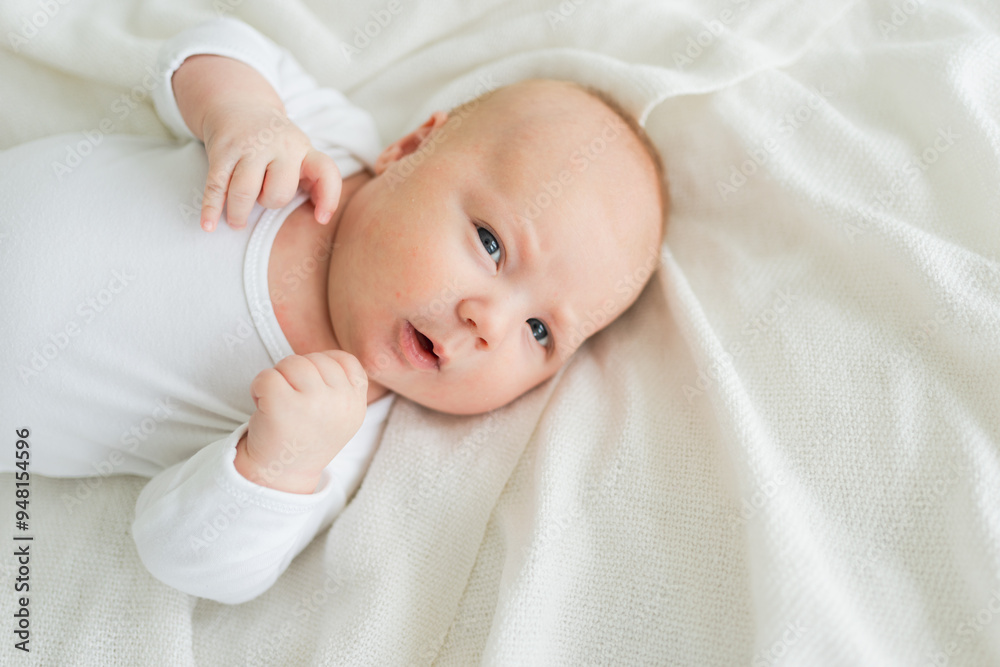 Happy baby. Cute little newborn girl with smiling face lying on bed in bedroom. Infant baby resting playing lying down on white blanket at home. Motherhood happy child childcare concept Happy baby. Cute little newborn girl with smiling face lying on bed in bedroom. Infant baby resting playing lying down on white blanket at home. Motherhood happy child childcare concept