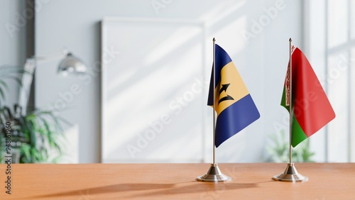 FLAGS OF BARBADOS AND BELARUS ON TABLE photo