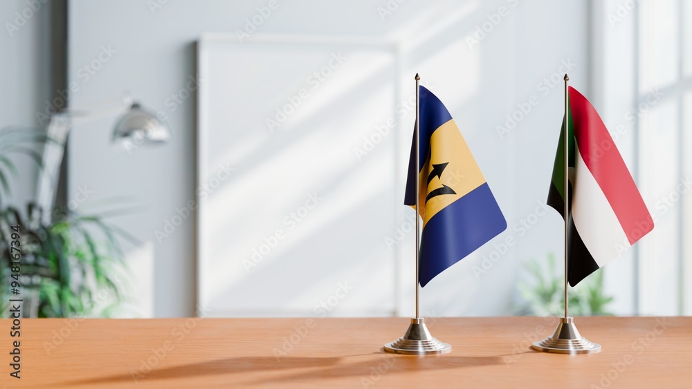 FLAGS OF BARBADOS AND SUDAN ON TABLE FLAGS OF BARBADOS AND SUDAN ON TABLE
