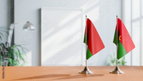 FLAGS OF BELARUS AND BURKINA-FASO ON TABLE photo