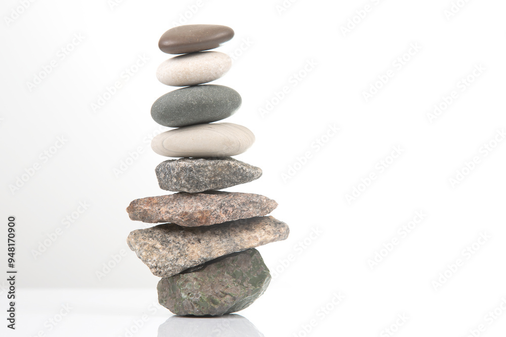 pyramid of stacked stones on a white background. stabilization and balance in life pyramid of stacked stones on a white background. stabilization and balance in life