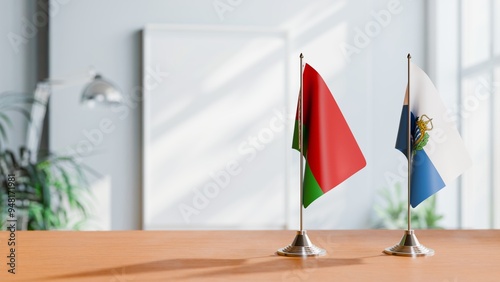 FLAGS OF BELARUS AND SAN MARINO ON TABLE photo