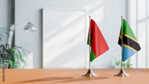 FLAGS OF BELARUS AND TANZANIA ON TABLE photo