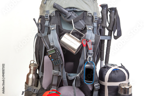 Items for tourism and hiking near a tourist backpack on a white background. set of equipment for tourism and travel