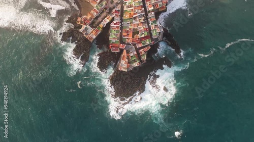 Aerial view of colorful houses and rocky coast along the ocean, Charcones Punta Brava, Puerto de la Cruz, Tenerife, Spain. photo