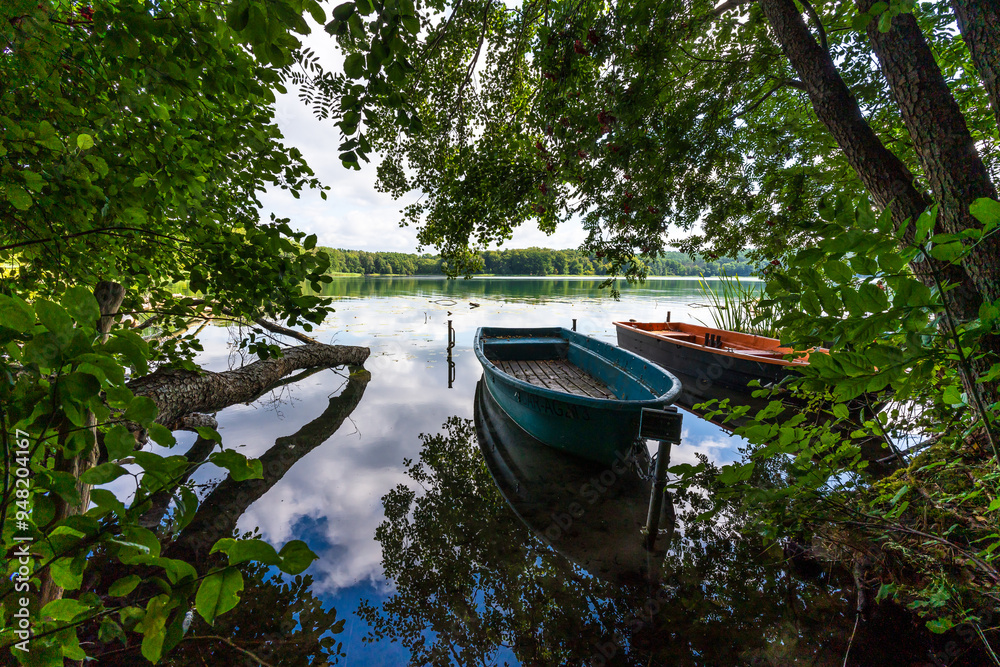 Small boats on the shore of a beautiful lake in summer Small boats on the shore of a beautiful lake in summer