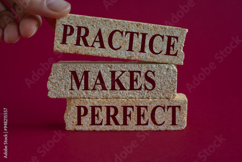 Obraz na płótnie Practice makes perfect symbol. Brick blocks with words Practice makes perfect on beautiful pink background. Businessman hand. Business practice makes perfect concept. w salonie