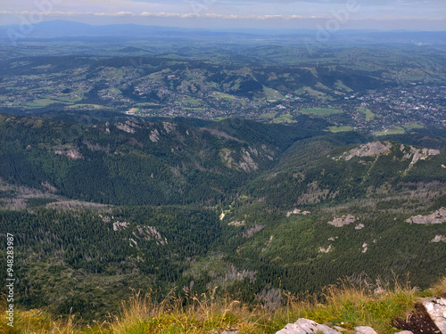 Enjoying the breathtaking view of the valley and the town below while standing on top of giewont mountain in the tatra national park