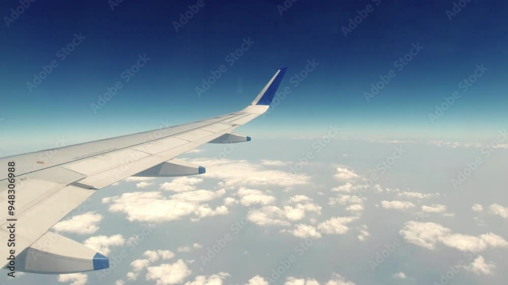 Scenic ariel view of clouds and wings of aircraft from the window Scenic ariel view of clouds and wings of aircraft from the window