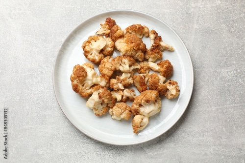 Baked cauliflower on light grey table, top view