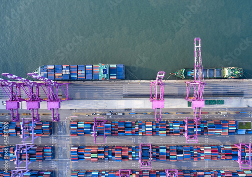 Songdo New City, Songdo-dong, Yeonsu-gu, Incheon, South Korea - September 12, 2021: Aerial and top angle view of cranes and container ships with stacked containers at Incheon New Port photo