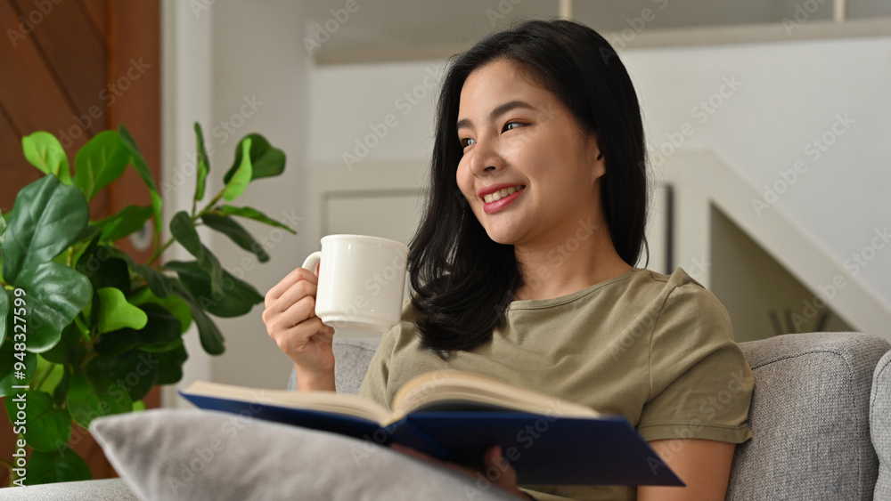 A young woman enjoys a relaxing moment on her couch, holding a cup of coffee and a book, surrounded by the calming ambiance of a plant-filled living space A young woman enjoys a relaxing moment on her couch, holding a cup of coffee and a book, surrounded by the calming ambiance of a plant-filled living space