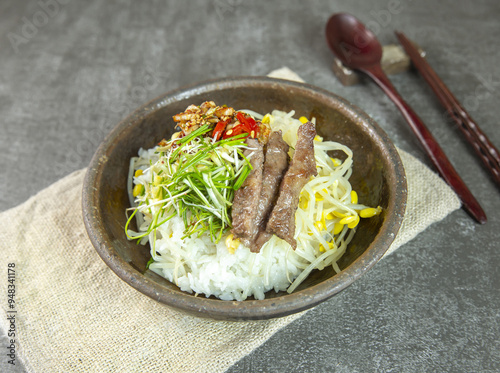 Close-up of Korean Food Kongnamul-bab(boiled rice cooked with bean sprouts and beef) on a ceramice bowl, South Korea photo