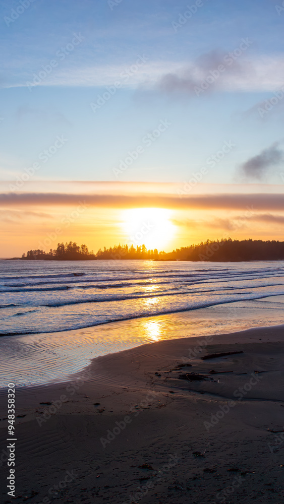 Sunset Over Tofino Beach with Silhouetted Trees and Calm Waves Sunset Over Tofino Beach with Silhouetted Trees and Calm Waves