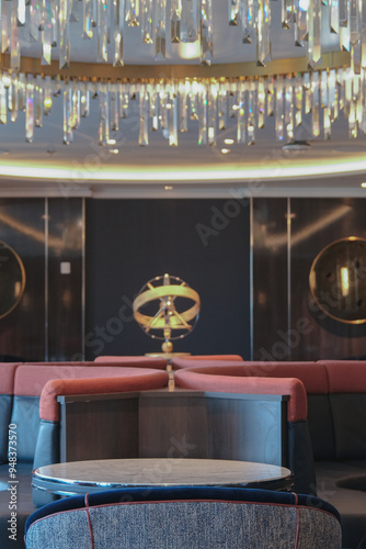 Gold Brass globe inside wood paneled Art Deco interior design architecture inside lounge bar public space onboard modern luxury cruiseship cruise ship liner with furniture crystal chandelier photo