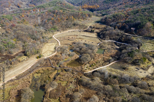 Aerial and autumnal view of dirt trail and ponds at Dolline Wetland at Gulbongsan Mountain of Ugok-ri near Mungyeong-si, South Korea 