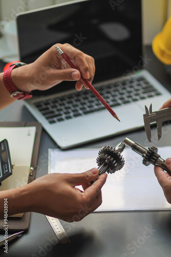 The factory mechanical engineering team is designing and developing gear sets to keep the machines running perfectly because gear sets are essential in the working system of large machines.