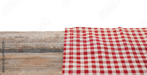 Tablecloth with checkered pattern on wooden table against white background