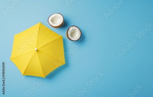 Beach concept based on coconut fruit and a sun umbrella. Creative minimal summer idea.
