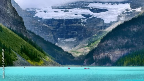 A serene turquoise Lake Louise, nestled between towering mountains, with a glacier-capped peak in the background. Small boats float peacefully on the water.
