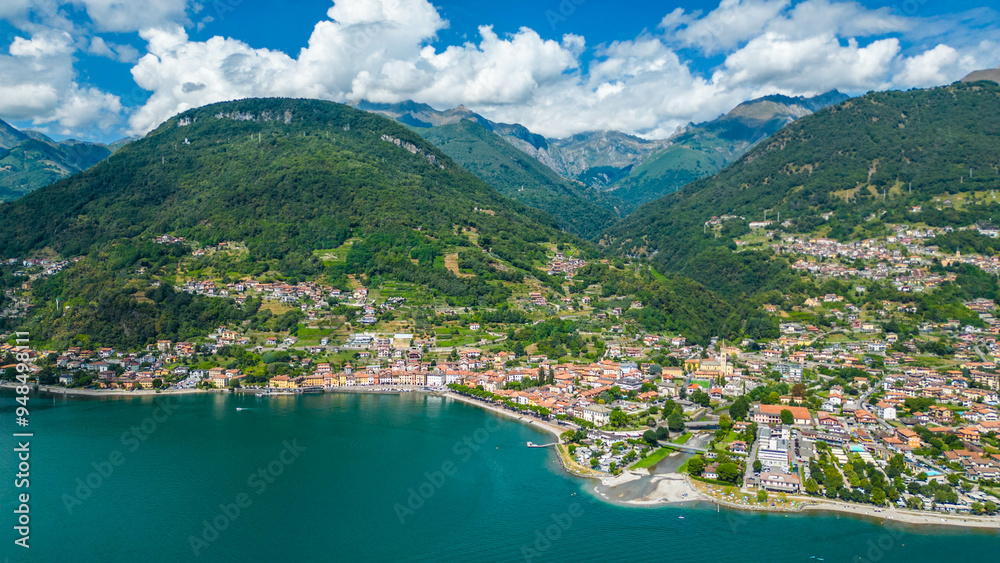 An aerial view of Domaso, a beautiful village nestled on the shores of Lake Como, Italy, captured by a drone. This charming destination is known for its picturesque lakeside scenery, quaint streets An aerial view of Domaso, a beautiful village nestled on the shores of Lake Como, Italy, captured by a drone. This charming destination is known for its picturesque lakeside scenery, quaint streets