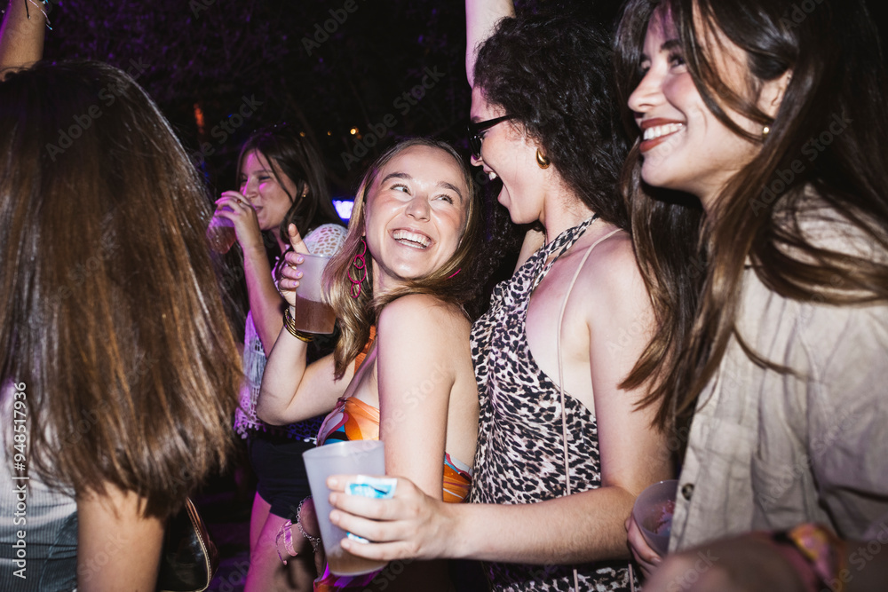 Group of young cheerful women dancing and laughing in a night club. Group of young cheerful women dancing and laughing in a night club.