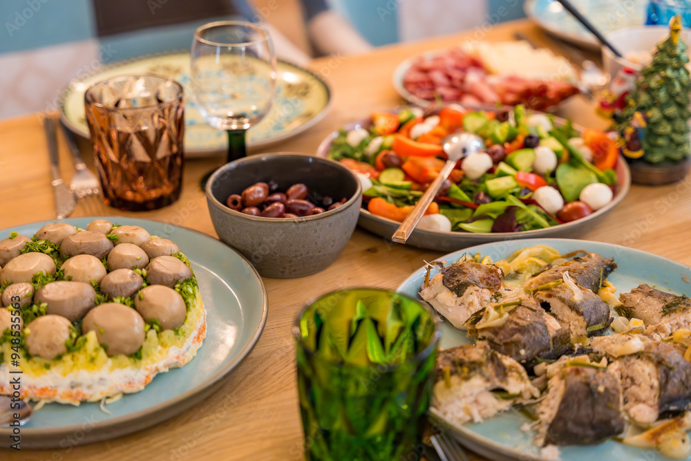 Cose-up of a festive Christmas dinner spread on a wooden table. Homemade dishes Cose-up of a festive Christmas dinner spread on a wooden table. Homemade dishes