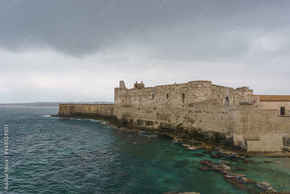 Ancient castle of Maniace at the coast on a cloudy rainy day, Syracuse, Sicily, Italy Ancient castle of Maniace at the coast on a cloudy rainy day, Syracuse, Sicily, Italy