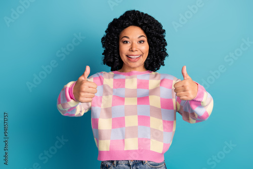 Photo portrait of attractive young woman thumb up approve dressed stylish pink plaid clothes isolated on blue color background