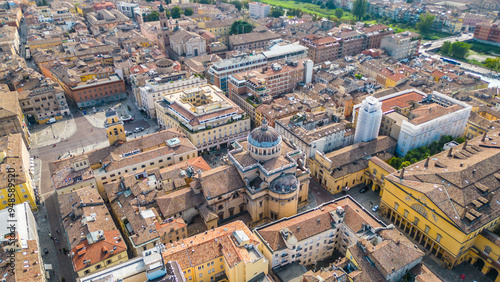 An aerial view of Parma, Italy, showcasing the iconic Cattedrale di Parma and the Battistero di Parma, captured by a drone.  This historic city is known for its rich cultural heritage photo