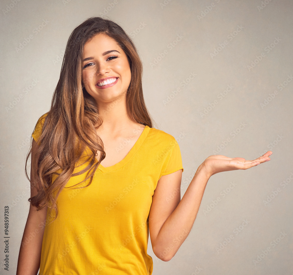 Portrait, woman and hand with presentation in studio for announcement, information or advertising. Female person, smile and happy with mockup space for news, marketing or promotion on gray background Portrait, woman and hand with presentation in studio for announcement, information or advertising. Female person, smile and happy with mockup space for news, marketing or promotion on gray background