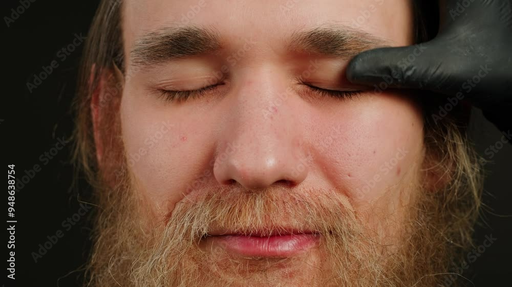 Make up artist making Disheveled blond beard for a man in theater with paint and glue, actors sfx cinema make up, close-up. Mens fashion, halloween style. making old guy. Make up artist making Disheveled blond beard for a man in theater with paint and glue, actors sfx cinema make up, close-up. Mens fashion, halloween style. making old guy.