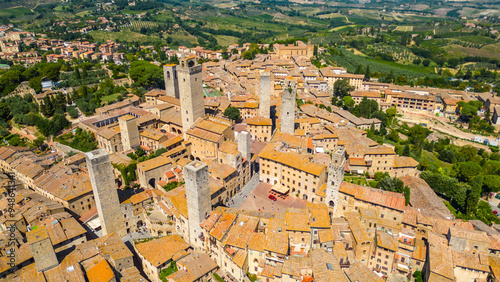 An aerial view of Certaldo, a charming medieval town in Tuscany, Italy, captured by a drone. Certaldo is known for its well-preserved historic center, characterized by ancient brick buildings photo