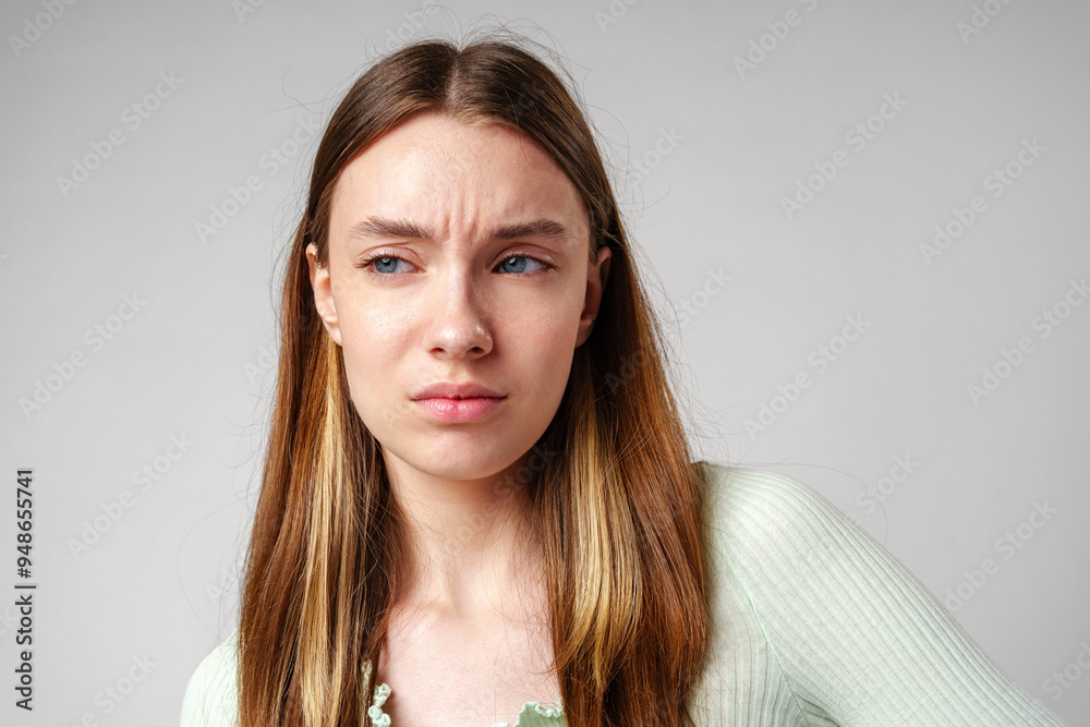 Fototapeta premium Young Woman With Frowning Expression in Portrait