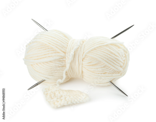 Skein of soft yarn with knitting needles and pattern sample isolated on white