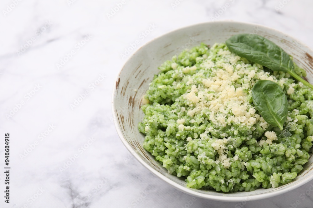 Tasty spinach risotto served on white marble table, closeup. Space for text Tasty spinach risotto served on white marble table, closeup. Space for text