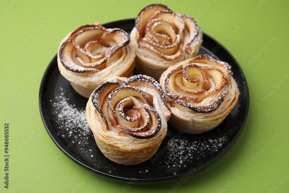 Freshly baked apple roses on green background, closeup Freshly baked apple roses on green background, closeup