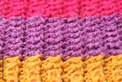 Texture of colorful knitted fabric as background, closeup