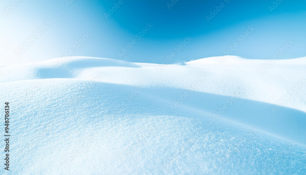 Obraz premium Panoramic view of a snow-covered landscape, with rolling hills and a clear blue sky. 