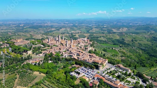 An aerial view of Certaldo, a charming medieval town in Tuscany, Italy, captured by a drone. Certaldo is known for its well-preserved historic center, characterized by ancient brick buildings photo