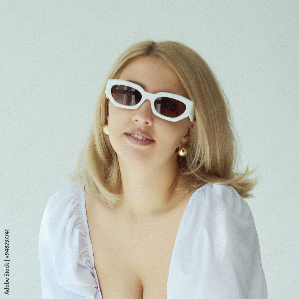 Front portrait of a sensual blonde young woman posing sensual in studio, wearing white dress. Front portrait of a sensual blonde young woman posing sensual in studio, wearing white dress.