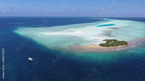 Aerial view of beautiful sandbank and turquoise lagoon with boats and reef, Rashdoo, Maldives. photo