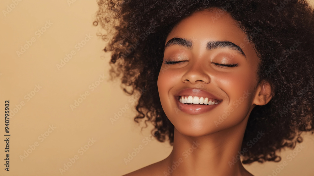 Close-up portrait of a joyful African American woman with curly hair, exuding happiness and confidence. Bright smile and glowing skin create a warm, engaging image suitable for beauty and lifestyle th Close-up portrait of a joyful African American woman with curly hair, exuding happiness and confidence. Bright smile and glowing skin create a warm, engaging image suitable for beauty and lifestyle th