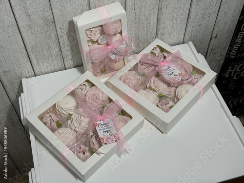 A box of homemade marshmallows. Tied with a ribbon. The tags have the inscription in Russian: 'Thank you for your invaluable work.' Flowers made of marshmallow photo